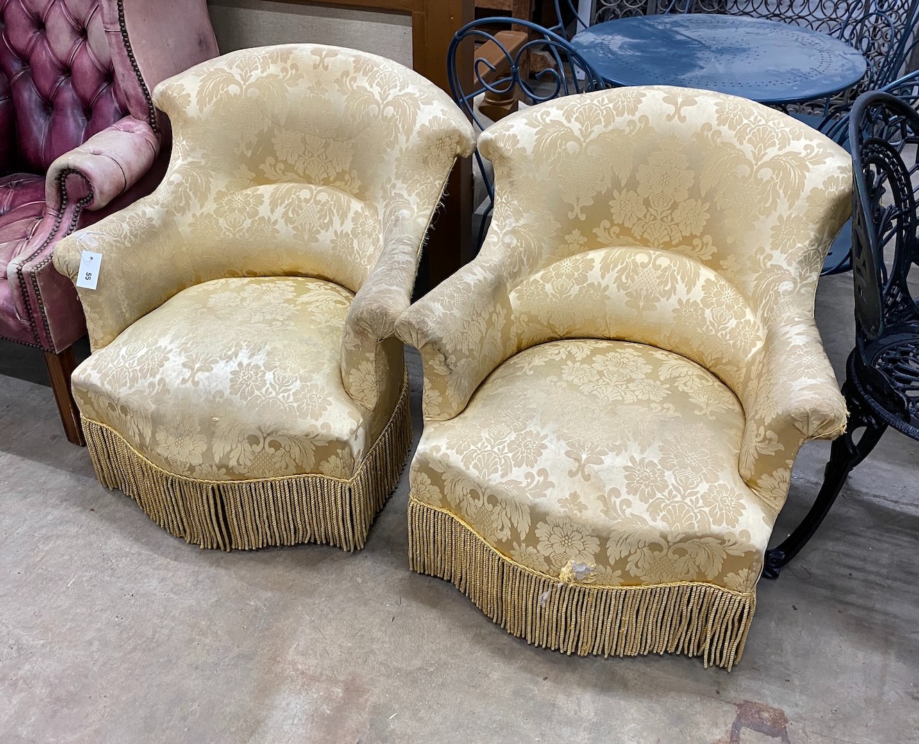 A pair of late Victorian upholstered tub framed armchairs